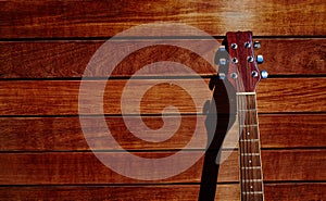 Acoustic brown guitar in wooden stripes