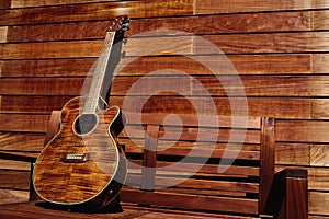 Acoustic brown guitar in wooden stripes