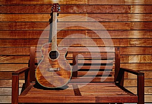 Acoustic brown guitar in wooden stripes