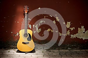 Acoustic guitar against grungy wall