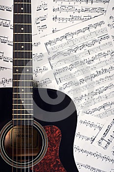 Acoustic guitar on a background sheet notes