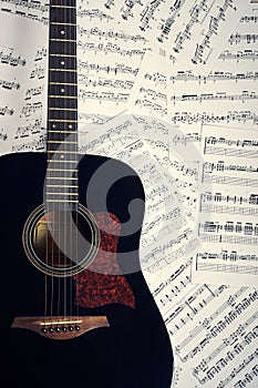 Acoustic guitar on a background sheet notes