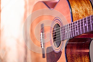 Acoustic guitar on a beautiful colored background. The concept of stringed instruments