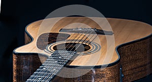 Acoustic guitar with a beautiful wood on a black background