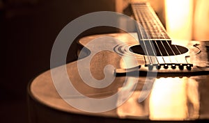 Acoustic guitar close-up on a beautiful colored background