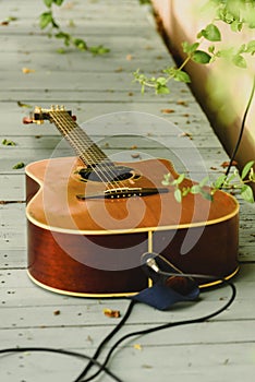 Acoustic guitar connected, on the floor