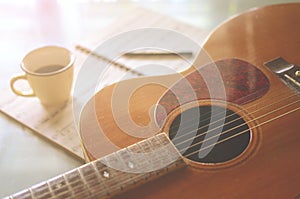 Acoustic guitar and  a cup of coffee on  background