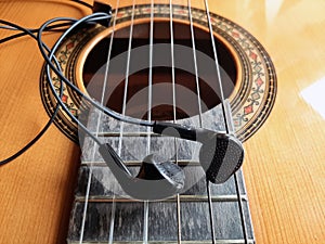 Acoustic Guitar and earphones. Retro style guitar and a earphones.