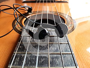 Acoustic Guitar and earphones. Retro style guitar and a earphones.