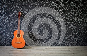 Acoustic guitar in empty room