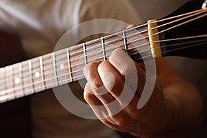 Acoustic guitar fingerboard detail and fingers doing a chord