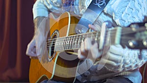 Acoustic guitar guitarist playing chords. Musical instrument with performer hands