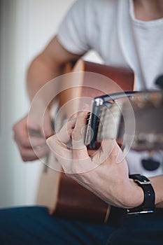 Acoustic guitar guitarist playing. Musical instrument with performer hands. joy of good music. Chord practice during quarantine.