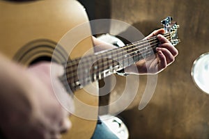 Acoustic guitar in the hands of the guy on the whole frame