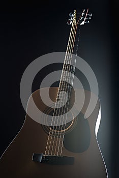 Acoustic guitar on isolated black background