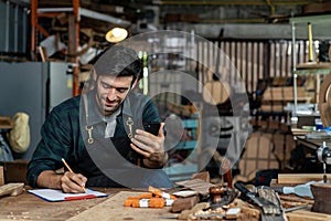 Acoustic Guitar Maker in Plaid Shirt and Apron Chatting with Customer