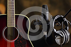 Acoustic guitar, microphone and earphones
