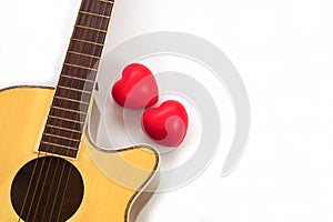 Acoustic guitar neck and red heart against white background. Love, relax and music concept.