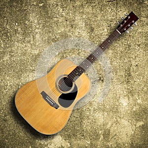 Acoustic guitar on old wall