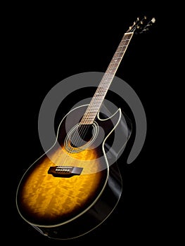Acoustic guitar over black background