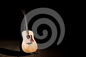 Acoustic guitar over dark background with copy space