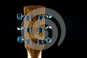 Acoustic Guitar Peg Head Rear View on a Black Background