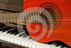 Acoustic guitar on piano keyboard