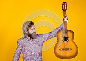 Acoustic guitar player. mature hipster musician with beard. brutal caucasian guy playing guitar. country music. bearded