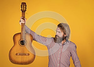 acoustic guitar player. mature hipster musician with beard. brutal caucasian guy playing guitar. country music. bearded