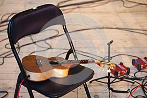 Acoustic guitar plugged in on music concert during break