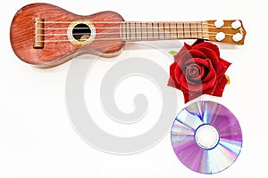 Acoustic guitar and red rose flower, isolated on white