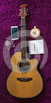 Acoustic guitar,smartphone,cup of coffee and blank notebook