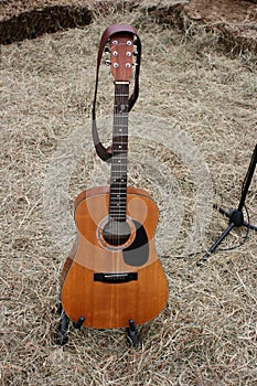 Acoustic Guitar and Straw on a farm