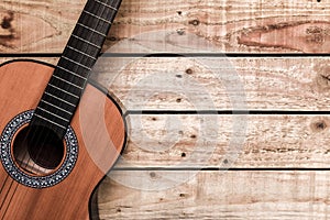 Acoustic guitar on vintage style wood background. Copy space with musical guitar instrument