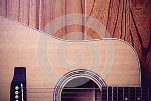 Acoustic Guitar on Wood Background