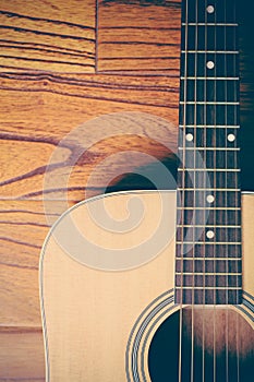Acoustic Guitar on Wood Background