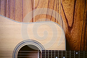 Acoustic Guitar on Wood Background