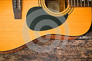 Acoustic guitar on a wooden background