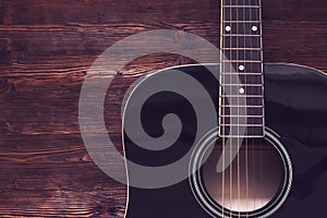 Acoustic guitar on wooden background