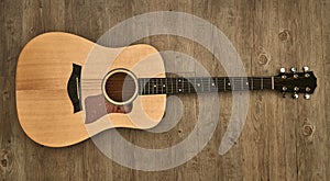 Acoustic guitar on a wooden floor