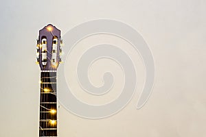 acoustic guitar wrapped in a luminous garland. Christmas gift
