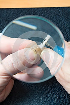 Acoustician working on a hearing aid photo