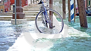 Acqua alta waves flooded small Italian city streets with steps