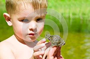 Acquaintance a little boy with a frog