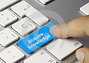 Acquire knowledge - Inscription on Blue Keyboard Key photo