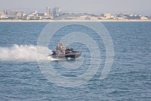 Acre, Israel - 11.05.2018: Sports active rest on the Mediterranean sea. Two young men racing on jet ski, water scooter. Active