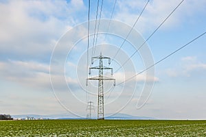 Acres with snow in winter with electricity tower
