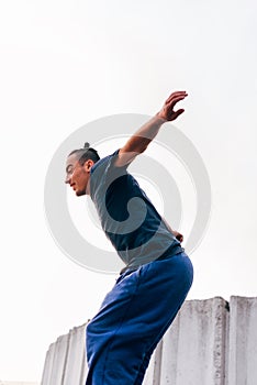 Acrobat man training parkour exercise while jumping