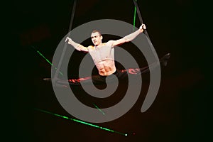 Acrobat performs a difficult trick in the circus.