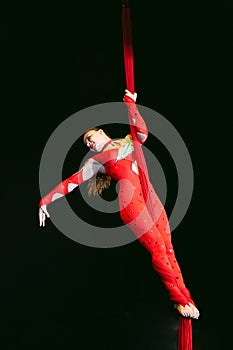 Acrobat performs a difficult trick in the circus.